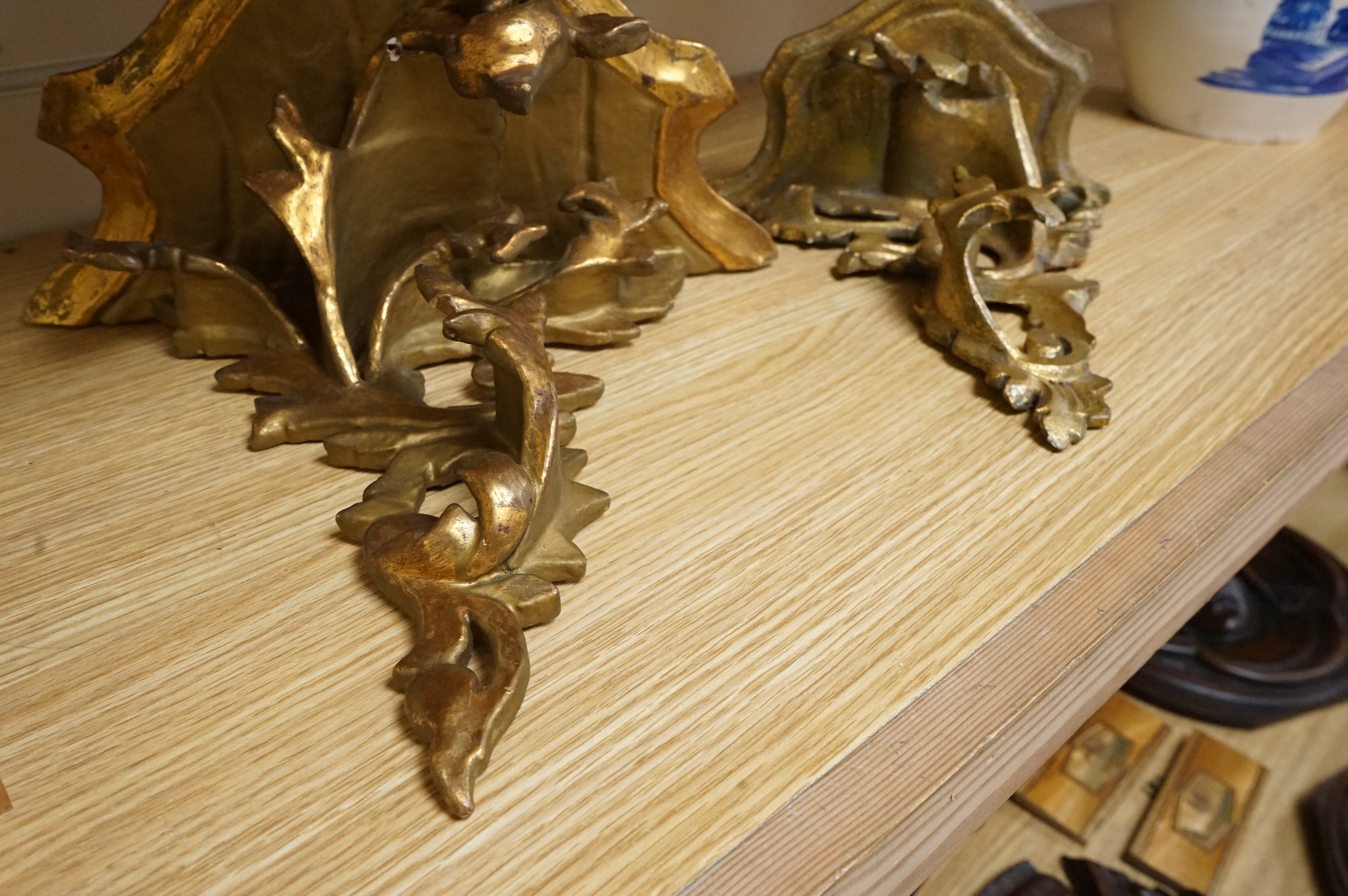 A large giltwood wall bracket- 28cm high together with a smaller similar wall bracket.